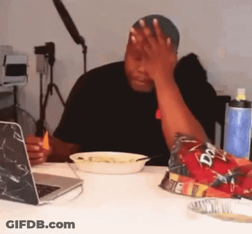 A Man Sitting At A Table With A Bag Of Doritos In Front Of Him GIF