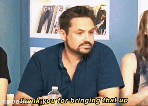 A Man Sitting At A Table With A Bottle Of Water Says Thank You For Bringing That Up GIF