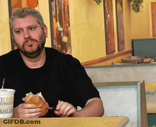 A Man Sitting At A Table With A Burger King Drink GIF