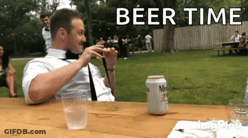 A Man Sitting At A Table With A Can Of Miller Lite Beer GIF