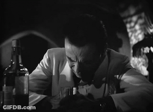 A Man Sitting At A Table With A Glass Of Gin And The Words Of All The Gin Joints GIF