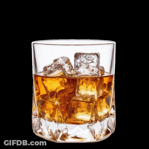 A Man Sitting At A Table With A Glass Of Whiskey And A Prayer GIF