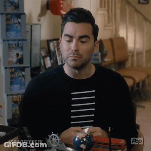 A Man Sitting At A Table With A Globe And A Pop Logo On The Bottom Right GIF