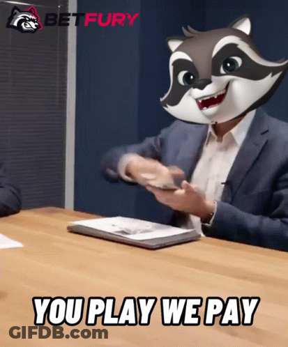 A Man Sitting At A Table With A Raccoon Mask On His Head And The Words You Play We Pay Below Him GIF
