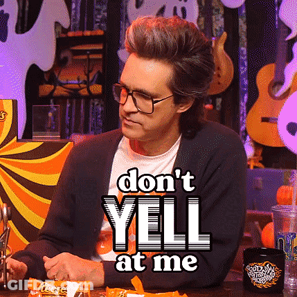 A Man Sitting At A Table With A Sign That Says " Do N't Yell At Me " On It GIF