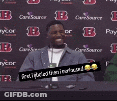 A Man Sitting At A Table With A Sign That Says " First I Boiled Then I Serious " GIF