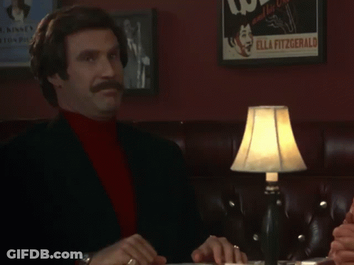 A Man Sitting At A Table With A Sign That Says Thank You Sir Or Madame GIF