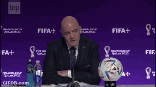 A Man Sitting At A Table With A Soccer Ball That Says Today I Feel On It GIF