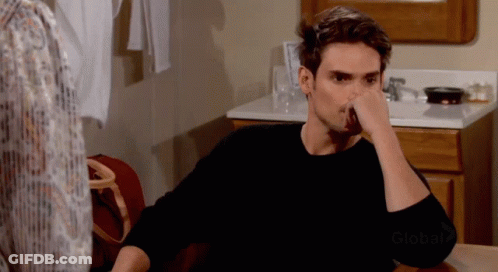 A Man Sitting At A Table With His Hand On His Face And The Word Global On The Bottom GIF