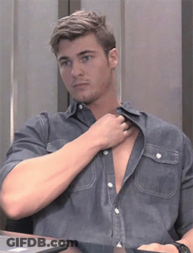 A Man Sitting At A Table With His Shirt Open GIF