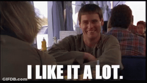 A Man Sitting At A Table With The Words " I Like It A Lot " Below Him GIF