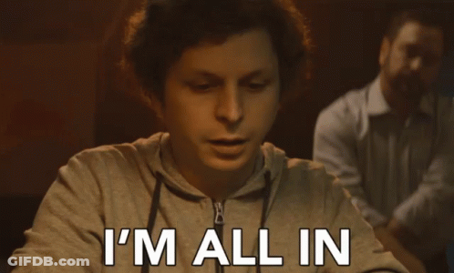A Man Sitting At A Table With The Words I 'M All In Written On His Face GIF