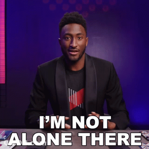A Man Sitting At A Table With The Words " I 'M Not Alone There " GIF