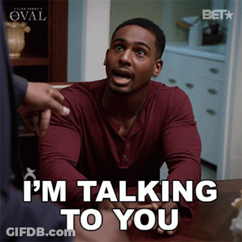 A Man Sitting At A Table With The Words I 'M Talking To You GIF
