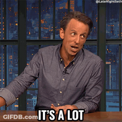 A Man Sitting At A Table With The Words It 'S A Lot On His Face GIF