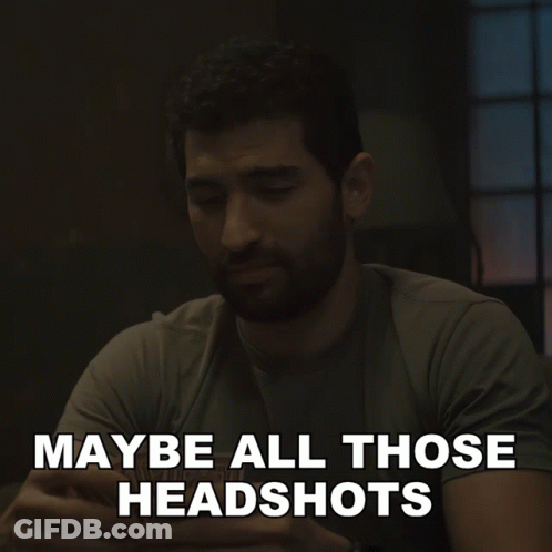 A Man Sitting At A Table With The Words " Maybe All Those Headshots " Written Below Him GIF
