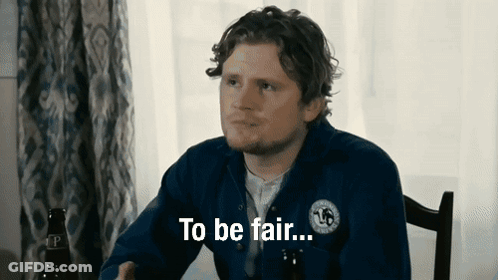 A Man Sitting At A Table With The Words To Be Fair Written On His Shirt GIF