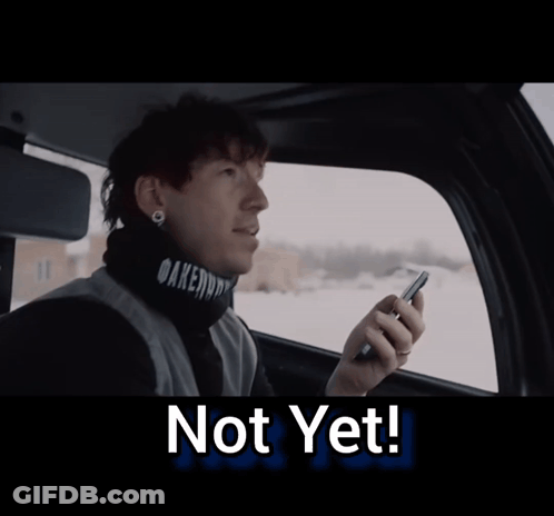 A Man Sitting In A Car Looking Out The Window With The Words Not Yet Below Him GIF
