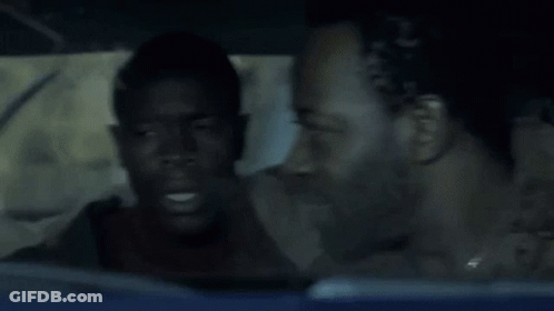 A Man Sitting In A Car With The Words Course I Am Above His Head GIF