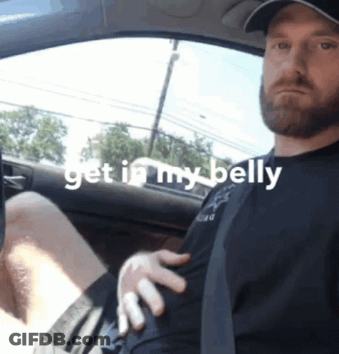 A Man Sitting In A Car With The Words Get In My Belly On The Bottom GIF
