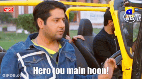A Man Sitting In A Car With The Words Hero Tou Main Hoon Above Him GIF