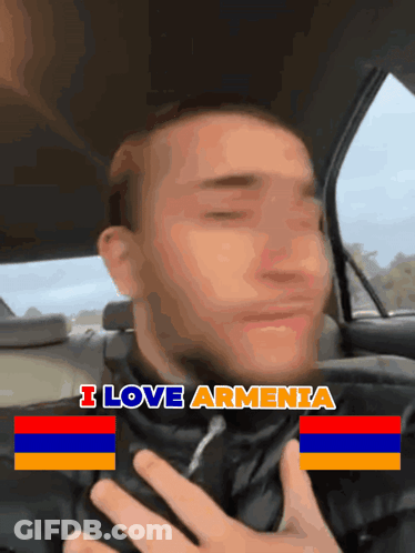 A Man Sitting In A Car With The Words I Love Armenia Above His Chest GIF