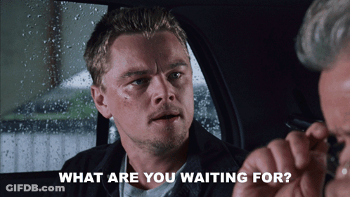 A Man Sitting In A Car With The Words " What Are You Waiting For " Next To Him GIF