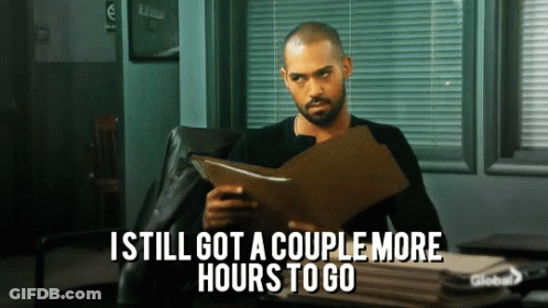 A Man Sitting In A Chair Holding A Clipboard With The Words " I Still Got A Couple More Hours To Go " GIF