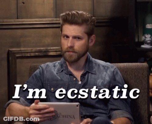 A Man Sitting In A Chair Holding A Tablet With The Words I 'M Ecstatic Written On It GIF
