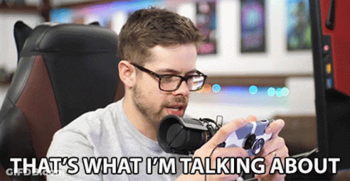 A Man Sitting In A Chair Holding A Video Game Controller With The Words That 'S What I 'M Talking About Below Him GIF