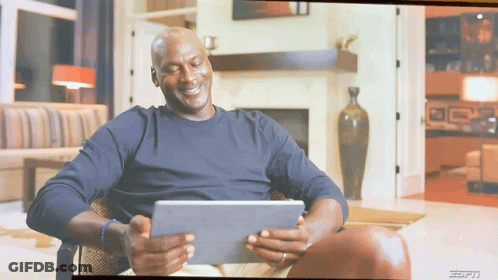A Man Sitting In A Chair Looking At A Tablet With The Espn Logo On The Bottom GIF
