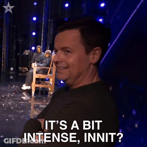 A Man Sitting In A Chair On A Stage Says It 'S A Bit Intense Innit GIF