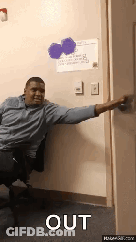 A Man Sitting In A Chair Reaching Out To Open A Door With The Word Out Written On The Bottom GIF