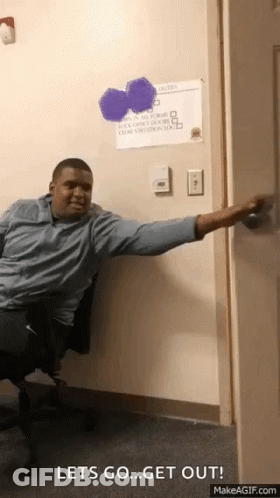 A Man Sitting In A Chair With His Arm Outstretched And A Sign On The Wall That Says " Let 'S Go " GIF