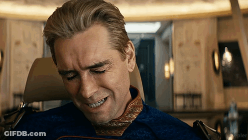 A Man Sitting In A Chair With His Eyes Closed And A Smile On His Face .. GIF