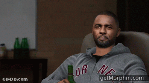 A Man Sitting In A Chair With His Feet Up And A Bottle Of Beer GIF