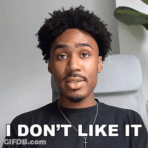 A Man Sitting In A Chair With His Tongue Sticking Out And The Words " I Don 'T Like It " Written On His Face GIF