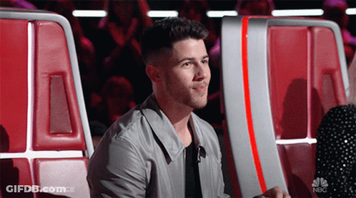 A Man Sitting In A Chair With The Word The Voice On The Bottom GIF