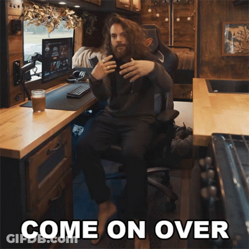 A Man Sitting In A Chair With The Words Come On Over Written Above Him GIF