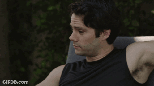 A Man Sitting In A Chair With The Words " I 'M Listening " Behind Him GIF