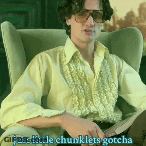 A Man Sitting In A Chair With The Words Just Little Chunklets Gotcha Written Below Him GIF