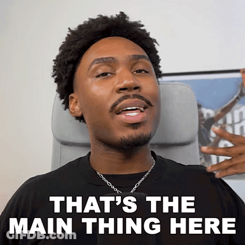 A Man Sitting In A Chair With The Words That 'S The Main Thing Here On His Face GIF