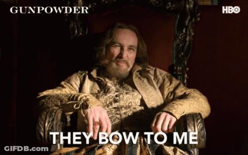 A Man Sitting In A Chair With The Words " They Bow To Me " Written On The Bottom GIF