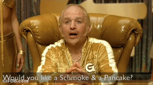 A Man Sitting In A Chair With The Words Would You Like A Schmoke And A Pancake GIF