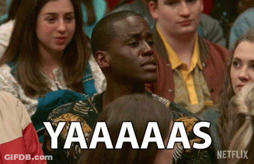 A Man Sitting In A Crowd With A Netflix Logo On The Bottom GIF