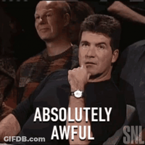 A Man Sitting In A Crowd With The Words " Absolutely Awful " On The Screen GIF