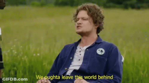 A Man Sitting In A Field With The Words We Oughta Leave This World Behind Below Him GIF