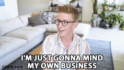 A Man Sitting In A Living Room With The Words I 'M Just Gonna Mind My Own Business GIF