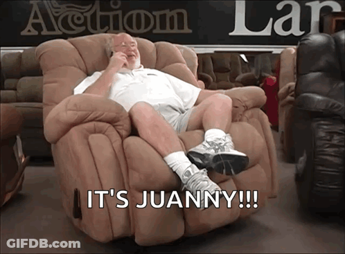 A Man Sitting In A Recliner With The Words It 'S Juanny Written Below Him GIF