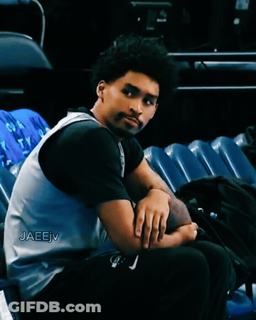 A Man Sitting In A Stadium With The Name Jaeejv Written On His Jersey GIF